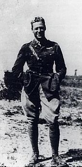 A man standing in a relaxed pose dressed in military attire.