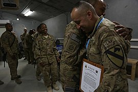 A U.S. Soldier with the 2nd Battalion, 7th Cavalry Regiment, 1st Cavalry Division congratulates Staff Sgt. Renie Arana, right, during an Audie Murphy Award ceremony at Bagram Airfield, Parwan province 130510-A-XM609-067.jpg