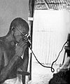 Gandhi at the telephone, Segaon, 1939.