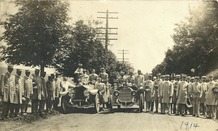 A fire department group photograph showing members and vehicles