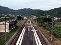 A view of the station platform looking north. The siding can be seen branching to the left.