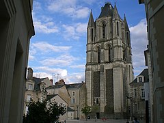 Photographie d'une tour médiévale en schiste, au milieu d'édifices moins hauts.