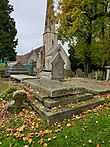 Photograph of the grave of Louisa Cooke, née Hardy, with St Peter's Church, Leckhampton, shown in the background