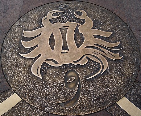 A manhole cover in Toulouse decorated with zodiac sign Cancer