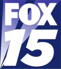 On a navy blue box with sublimated searchlights, the Fox network logo in white below an italicized white 15 in a sans serif.