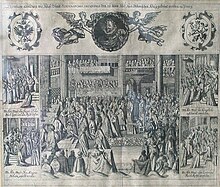 A bishop crowns a kneeling man in a large church filled with dozens of men