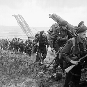 Royal Marine Commandos attached to 3rd Infantry Division move inland from Sword Beach, 6 June 1944.