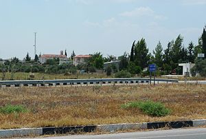 Angastina, Cyprus, 2012. Viewed from the northern Nicosia to Famagusta highway. Note the bell tower of Agia Paraskevi right of the communications tower