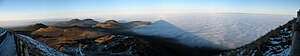 Shadow of the Puy-de-Dôme on the clouds (viewed from the Puy-de-Dôme summit). Chaîne des Puys' volcanoes on the left