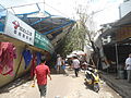 Typhoon Rammasun (2014) in Haikou – worker housing blown down, crushing shops (18 July 2014).