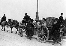 B&W of people on a packed cart