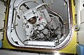 Daniel Bursch (left) and Carl E. Walz are photographed in the crew lock of Quest prior to the space walk