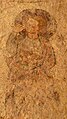 Détail de la peinture médiévale sur un des murs de la chapelle Saint-Sauveur. En mauvais état, on distingue encore quelques détails du personnage : sans doute un saint comme en témoigne l'auréole.