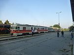 Prilep train station. Passengers are boarding the morning train to Skopje, a historical steam loco parked in sidings.