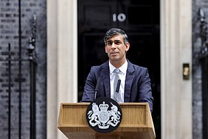 Sunak outside 10 Downing Street, standing at a wooden lectern