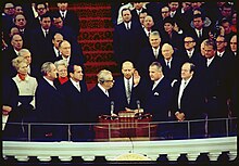 On the Inauguration podium, Agnew is sworn in as Nixon and others look on