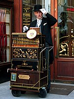 A street organ (locally called Werklmann) player with his paper roll-driven Berlin-style barrel organ in Vienna
