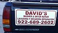 Washing machine repairman advertising on his truck, in English and Spanish, English on top, Texas