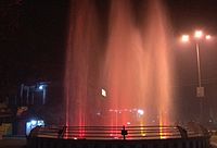 Fountain display under coloured lighting