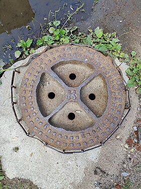 Old manhole cover in St. Petersburg. Probably, concrete was reinforced to replace the cast-iron body.