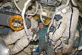 Koichi Wakata, is pictured between two Russian Orlan spacesuits in the Pirs module.