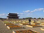 Birds eye view of a palace with several large structures surrounded by a rectangular corridor.