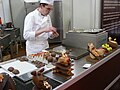 chocolatier making chocolate eggs of half eggs - Choco-Laté chocolate fair, Brugge 2007, Belgium