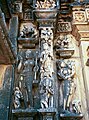 Ladies of the Heavenly Court.Ambika Mata temple, Jagat. This section of the wall is decorated with goddesses in various postures: holding an Eka-tantri vina (photo left), playing a vina (type unknown) while supported by an elephant (photo center), and holding a child (photo right).