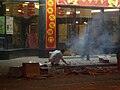 A Shanghainese man setting off firecrackers