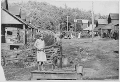 Pumping water by hand from the sole water supply in this section of Wilder, Tennessee in Fentress County (Tennessee Valley Authority, 1942)