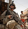 A US Soldier patroling in the Hariyah district of Baghdad, armed with a M249