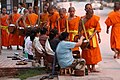 Buddhist monks collecting alms at dawn in Luang Prabang