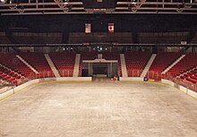 An empty arena with the sheet of ice and the score board