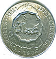 Anverso de moneda de 8 reales (plata) de Carlos IV de 1806 con resello de Omán.