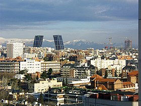 Partial view of Chamartín district in Madrid (Spain). In the background, Puerta de Europa inclined buildings (left) and CTBA business park under construction (right). Behind them, the Sierra de Guadarrama (land)