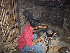 Man cooking at home in Laos.jpg