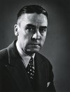 A photographic portrait of a man wearing a suit