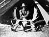 Carl Rungius astride a moose skull.