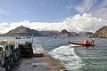 Image 27A boat leaving a slipway stacked with creels in Elgol Bay, Skye, with the Cuillin in the background Credit: Paul Hermans