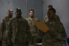 U.S. Army Staff Sgt. Latisha Brossard, right, with the 2nd Battalion, 7th Cavalry Regiment, 1st Cavalry Division, reads orders during an Audie Murphy award ceremony at Bagram Airfield, Parwan province 130510-A-XM609-030.jpg