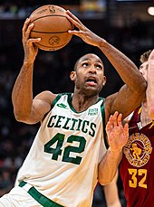 Image of Al Horford in a Celtics uniform in a basketball game attempting a lay up.