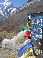 Buddhist prayer flags flutter at the highest point of the road pass
