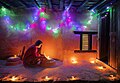 Woman lighting a diyo during Tihar