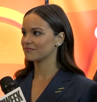 Fumero smiling at the 2019 NBC Upfront with a microphone for Adweek