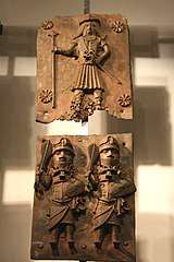 The Portuguese in Africa : brass plate depicting a Portuguese soldier (above) and native Benin warriors (below).