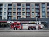 An Edmonton Fire Rescue Services ladder truck heading eastbound on Whyte Ave