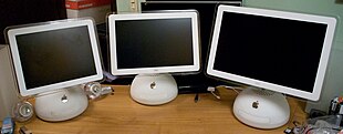 Three white computers arrayed side-by-side; they are identical save for their screens of differing sizes.