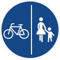 rundes Schild mit blauem Grund, links ein Fahrrad, unten Fußgänger, getrennt durch eine senkrechte weiße Linie