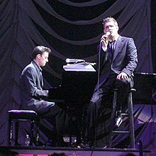 Alan Chang (left) on tour with Michael Bublé (right)