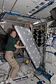 Sandra Magnus works on a crew quarters compartment